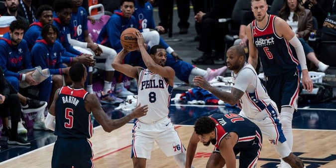 NBA players from the Washington Wizards team playing against the Philadelphia 76ers.