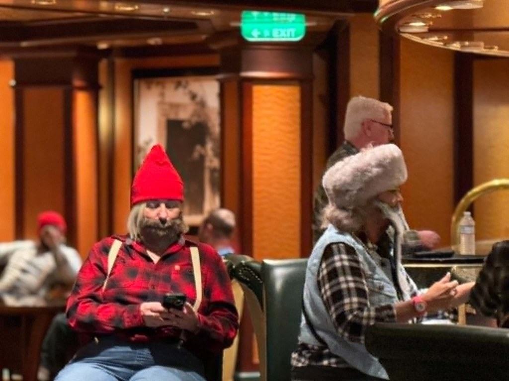 Angela Garcia and Lupe Soto dressed in flannel and fake beards for Lumberjack theme night on the Poker Player Cruises Alaska voyage