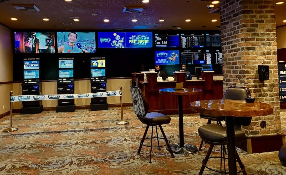Betting kiosks and a staffed sportsbook counter inside Boomer's Sportsbook at Binion's in downtown Las Vegas.
