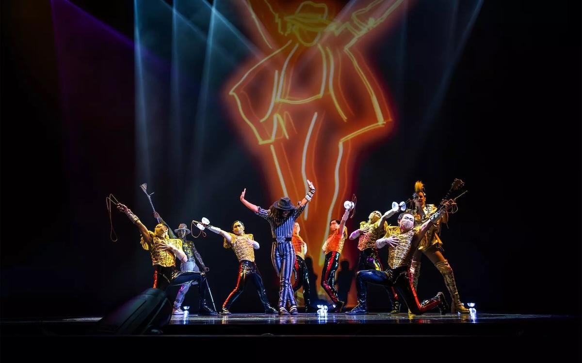 Dancers perform in front of a lit Michael Jackson silhouette in Michael Jackson ONE at Mandalay Bay