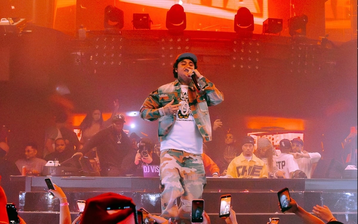 Rapper Ohgeesy performing on stage with crowd in the foreground