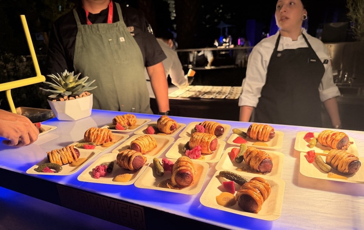 A tray of wagyu pigs in a blanket appetizers with pickles and mustard at Drink Las Vegas