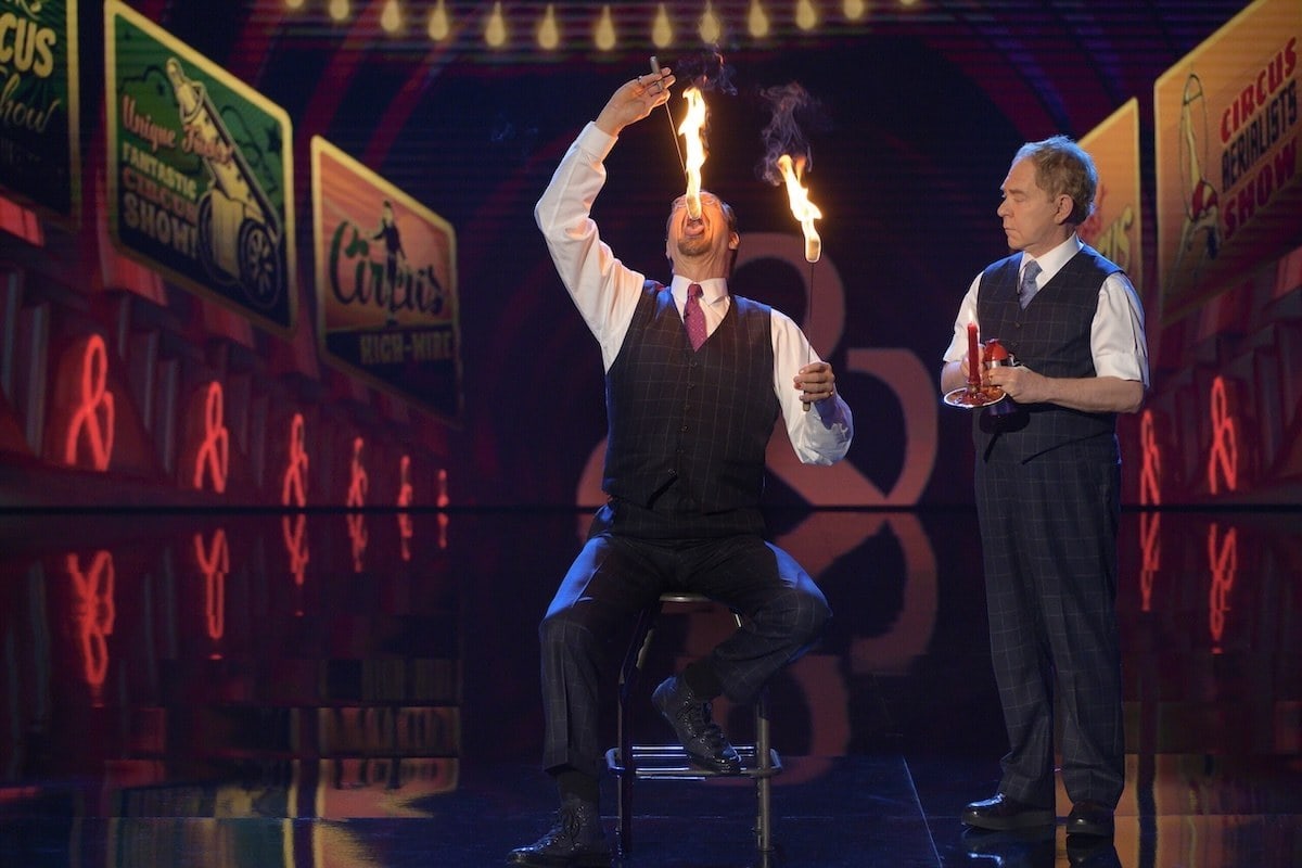 Penn and Teller performing a fire trick on stage at the Rio