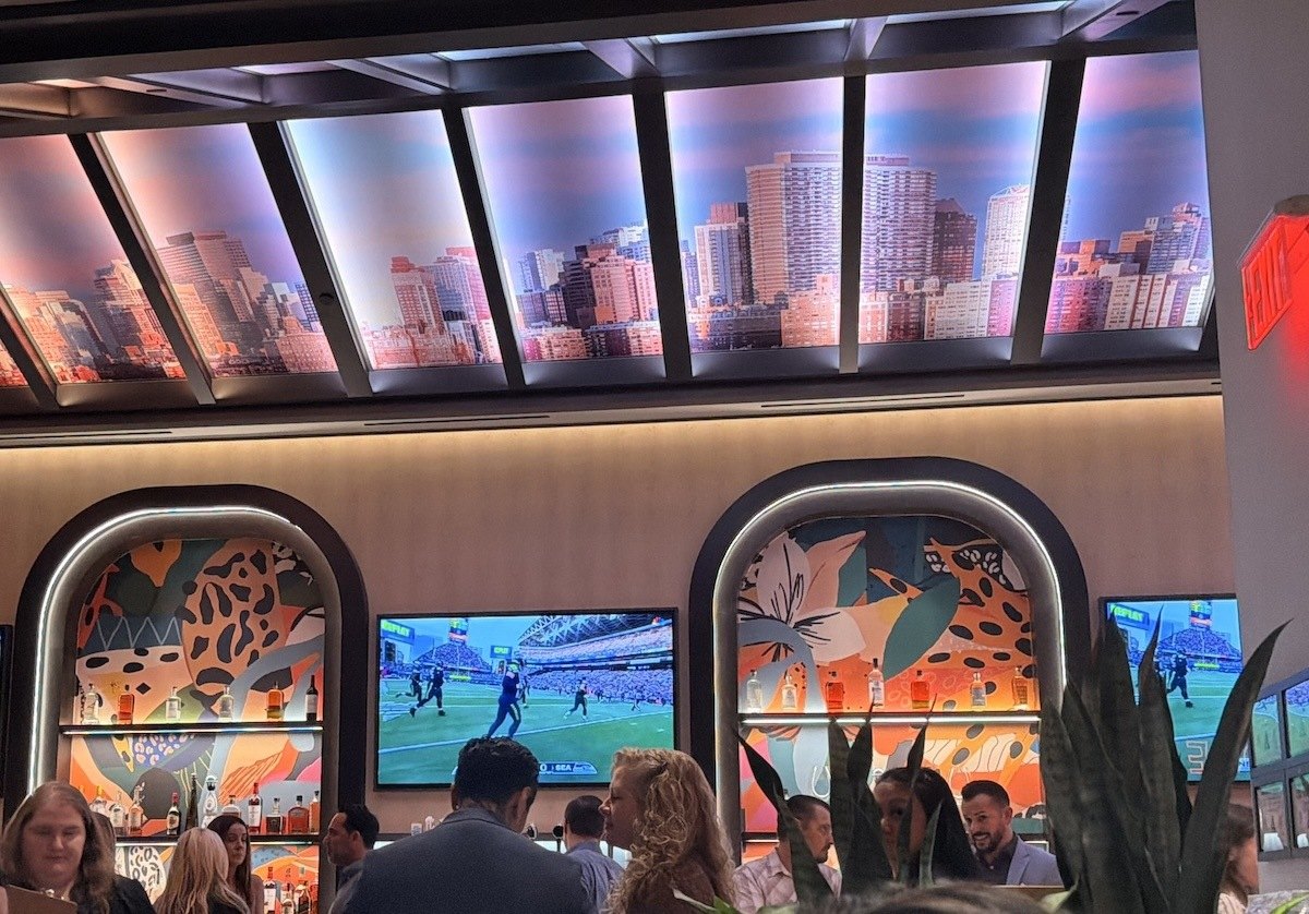 Ceiling panels featuring the New York City skyline above the bar at America restaurant