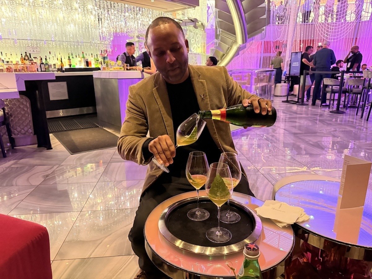 The All Day Dream cocktail, served in a tall glass with a basil garnish, at Chandelier Bar