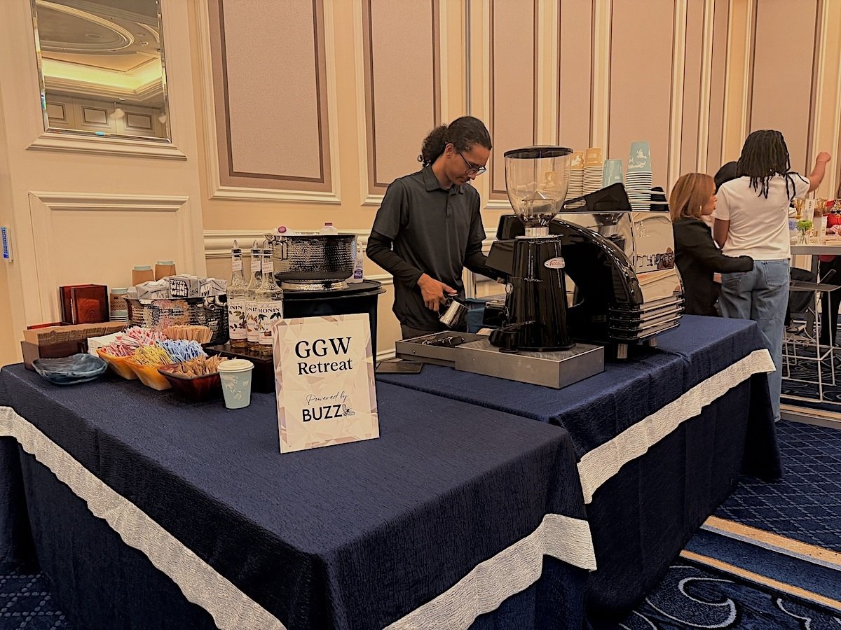 Barista preparing espresso at the Buzz Bar coffee station inside the Global Gaming Women Retreat