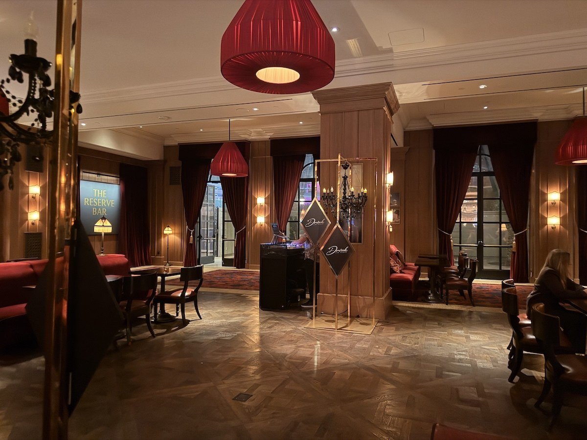 The dimly lit lounge interior of the Reserve Bar at Park MGM with red pendant lighting