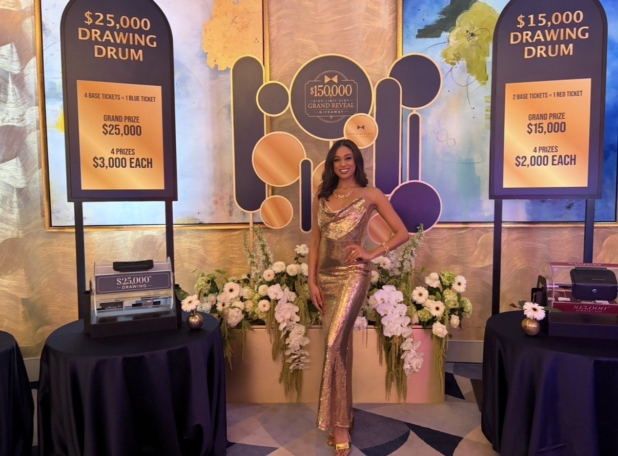 A performer in a gold sequined dress posing in front of Fontainebleau’s $25,000 and $15,000 drawing drum signage