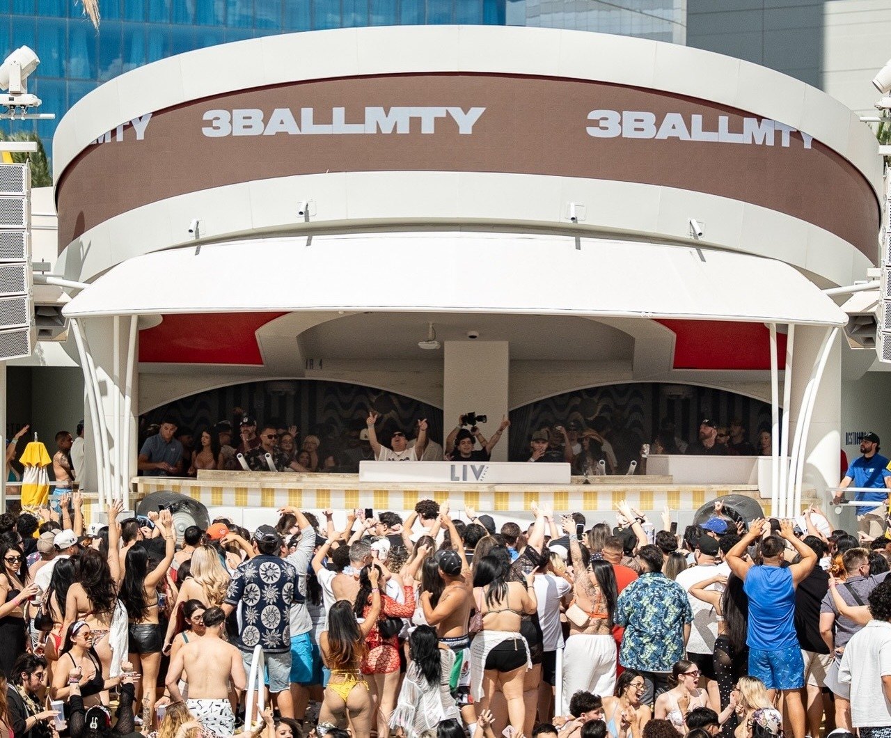 The group 3BallMTY performing on stage above a packed crowd at LIV