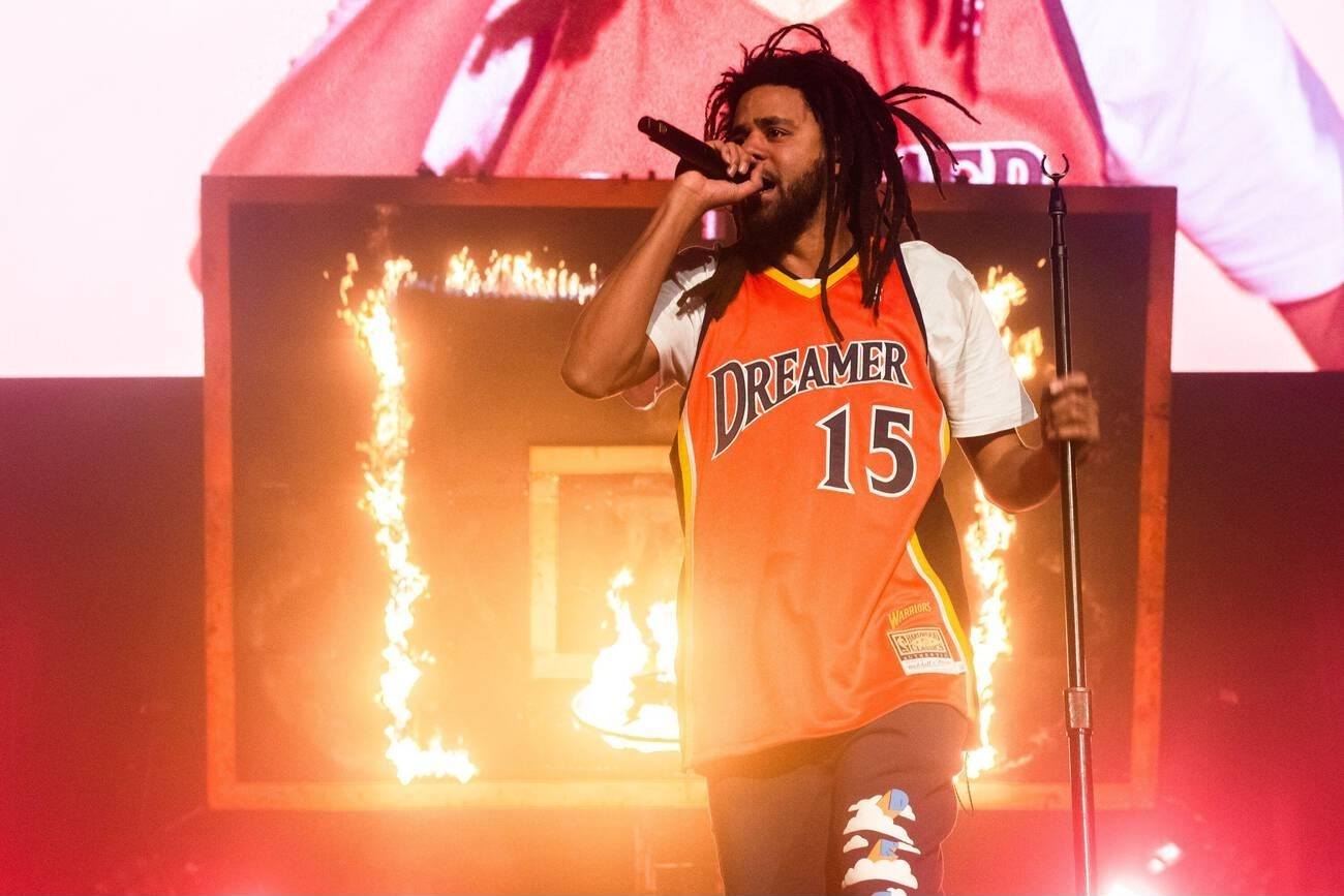 J. Cole performing on stage