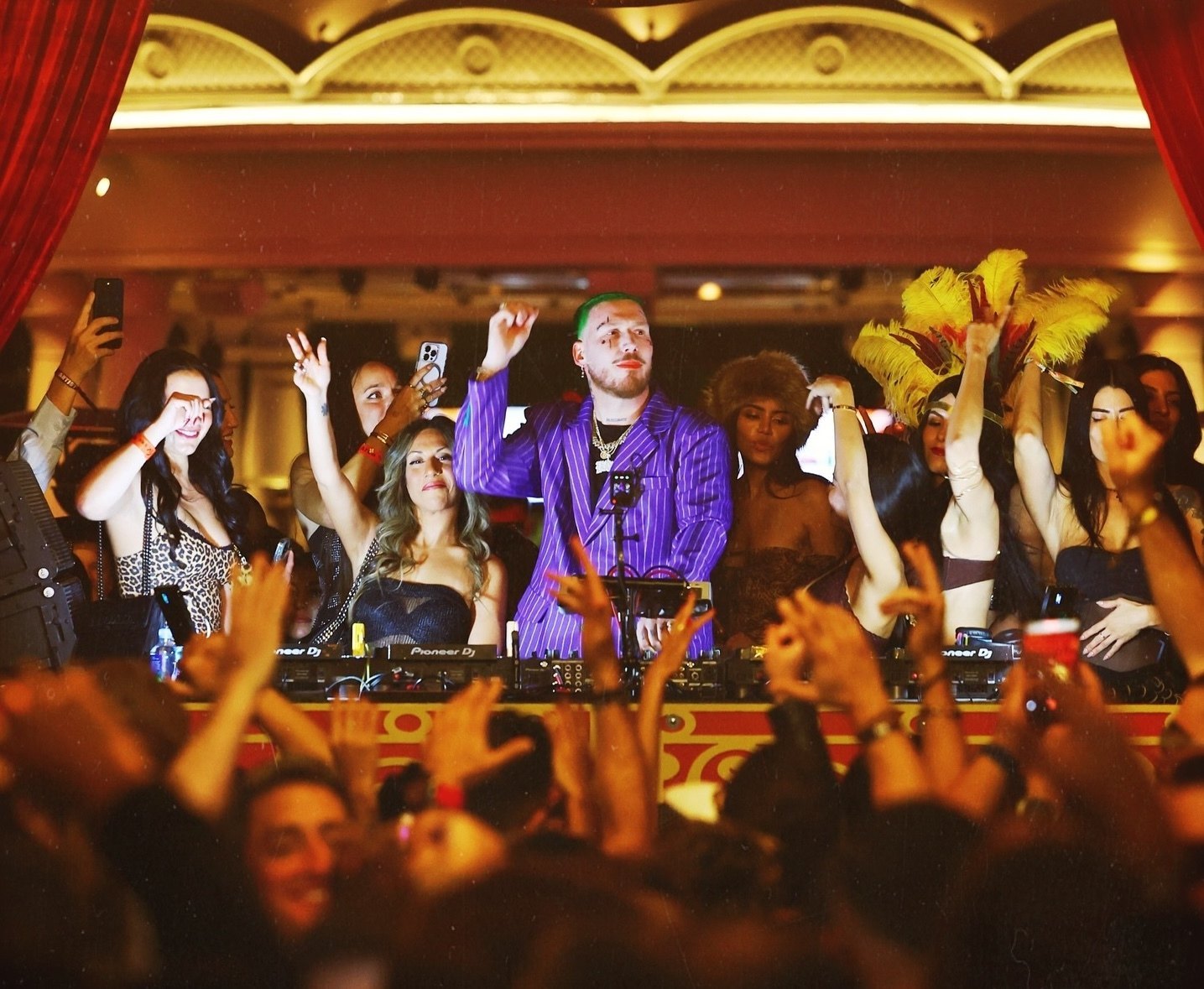 Hugel DJing in a purple pinstripe suit at XS Nightclub on Halloween 2025