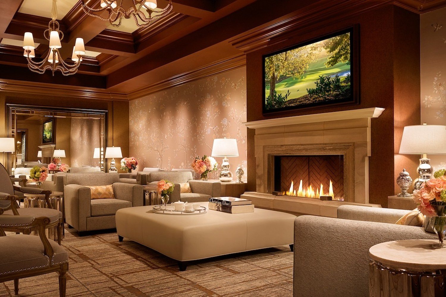 Women's waiting lounge at the Wynn Spa with a fireplace, TV and floral wallpaper