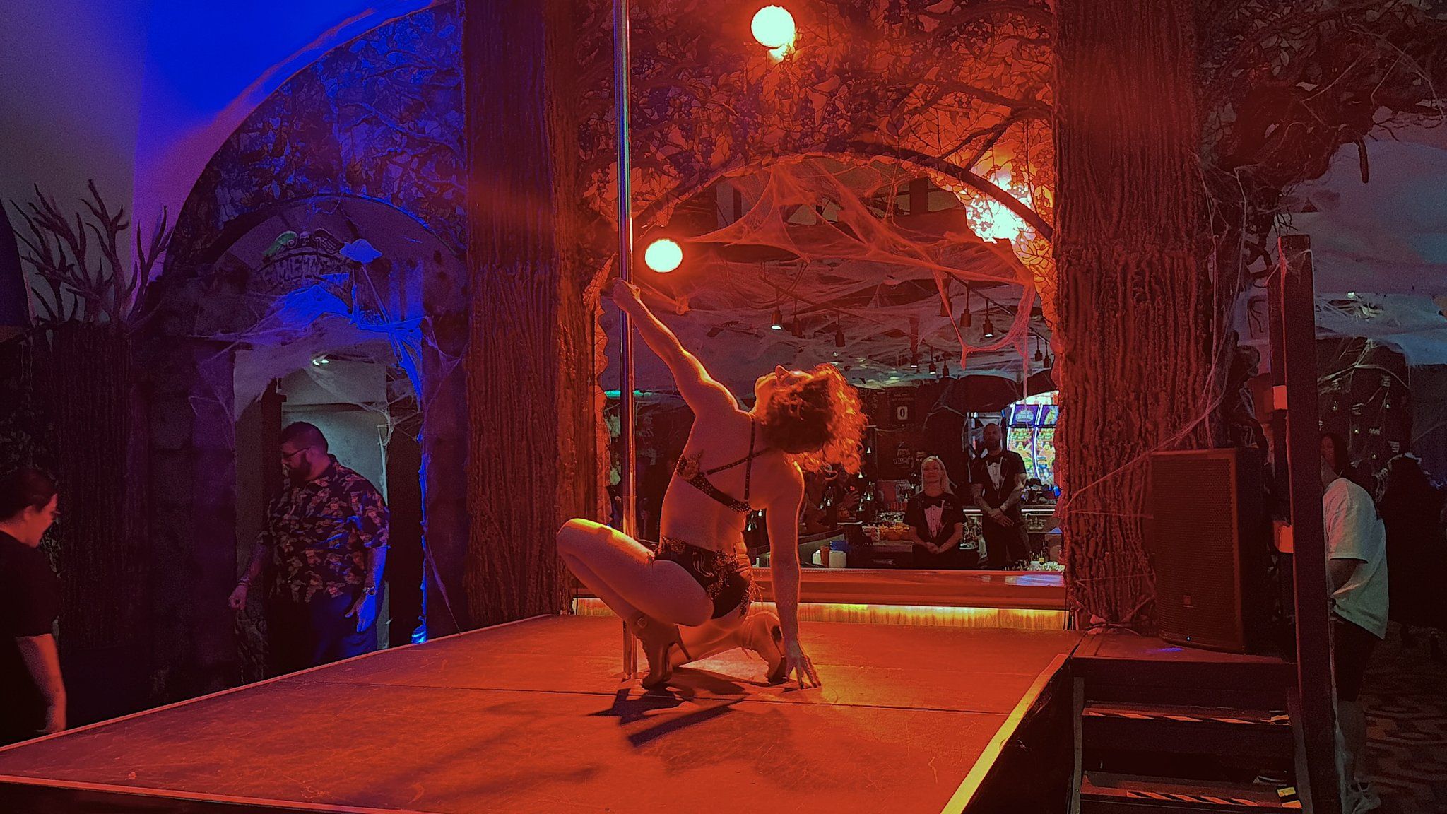 Lady Palms performs a pole-dance routine on stage at the Haunted Inn Halloween pop-up