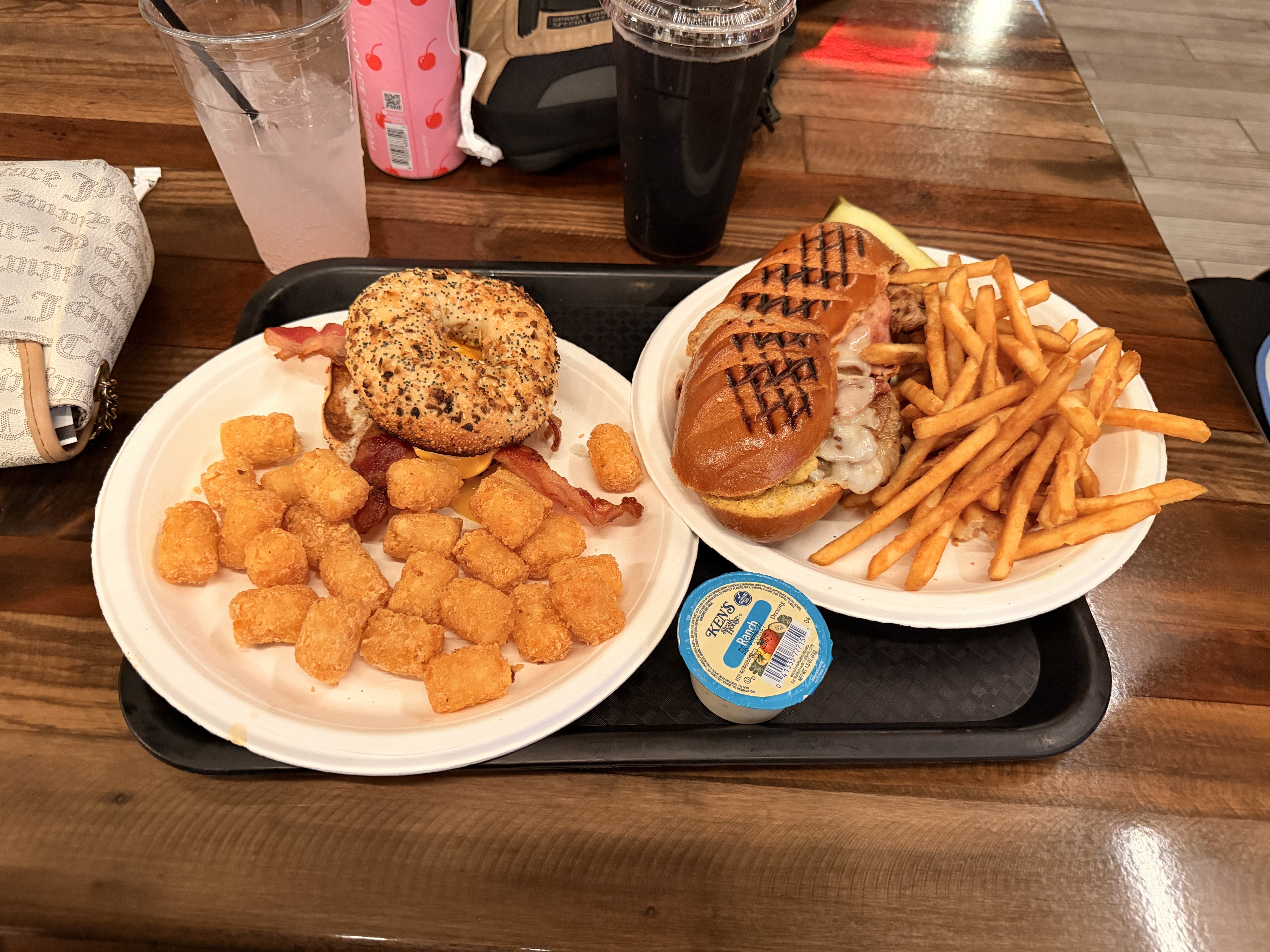 Bagel breakfast sandwich and Cubano sandwich with tots and fries at Backstage Deli