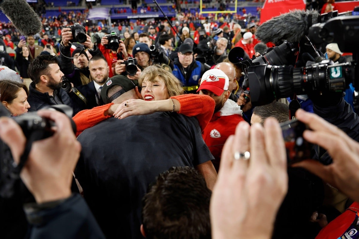 Taylor Swift and Travis Kelce hug at an NFL game