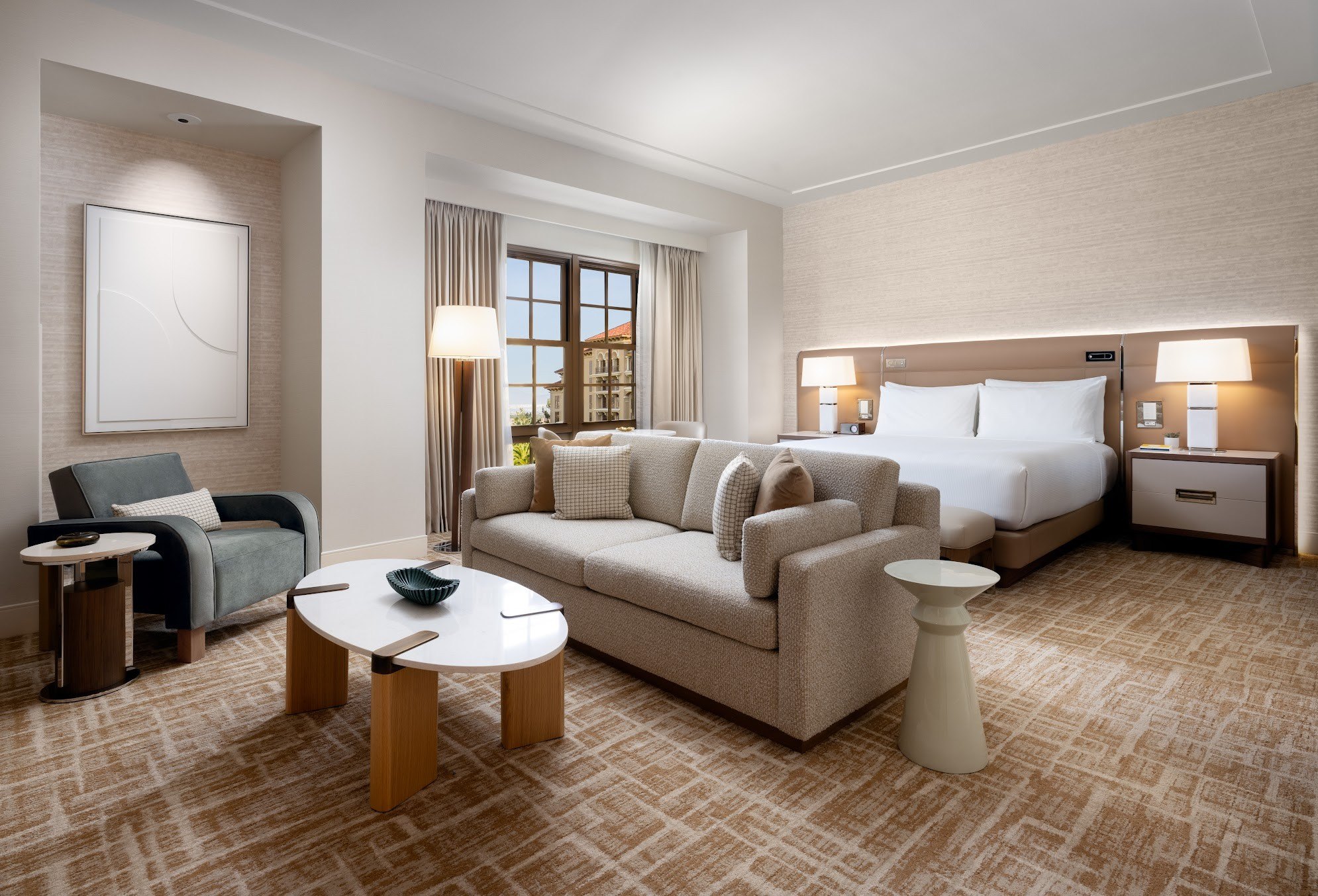 Renovated Green Valley Ranch Executive hotel room with a king bed, sofa seating area, and modern decorations.