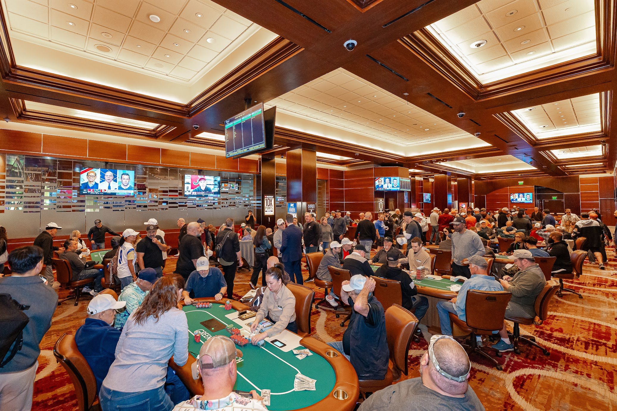 People sit at the tables and swarm the new poker room at Green Valley Ranch