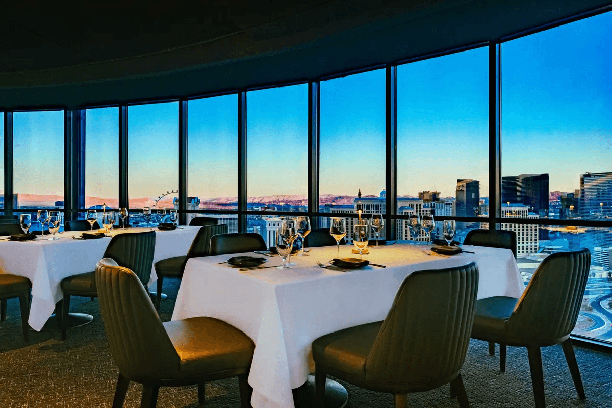 The dining room inside High Steaks Vegas at the Rio with a window looking at the Strip
