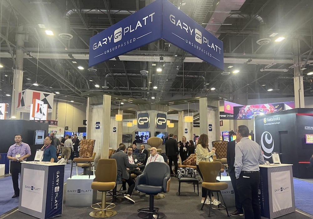 Gary Platt Seating booth at a gaming conference inviting attendees to sit and test casino chairs