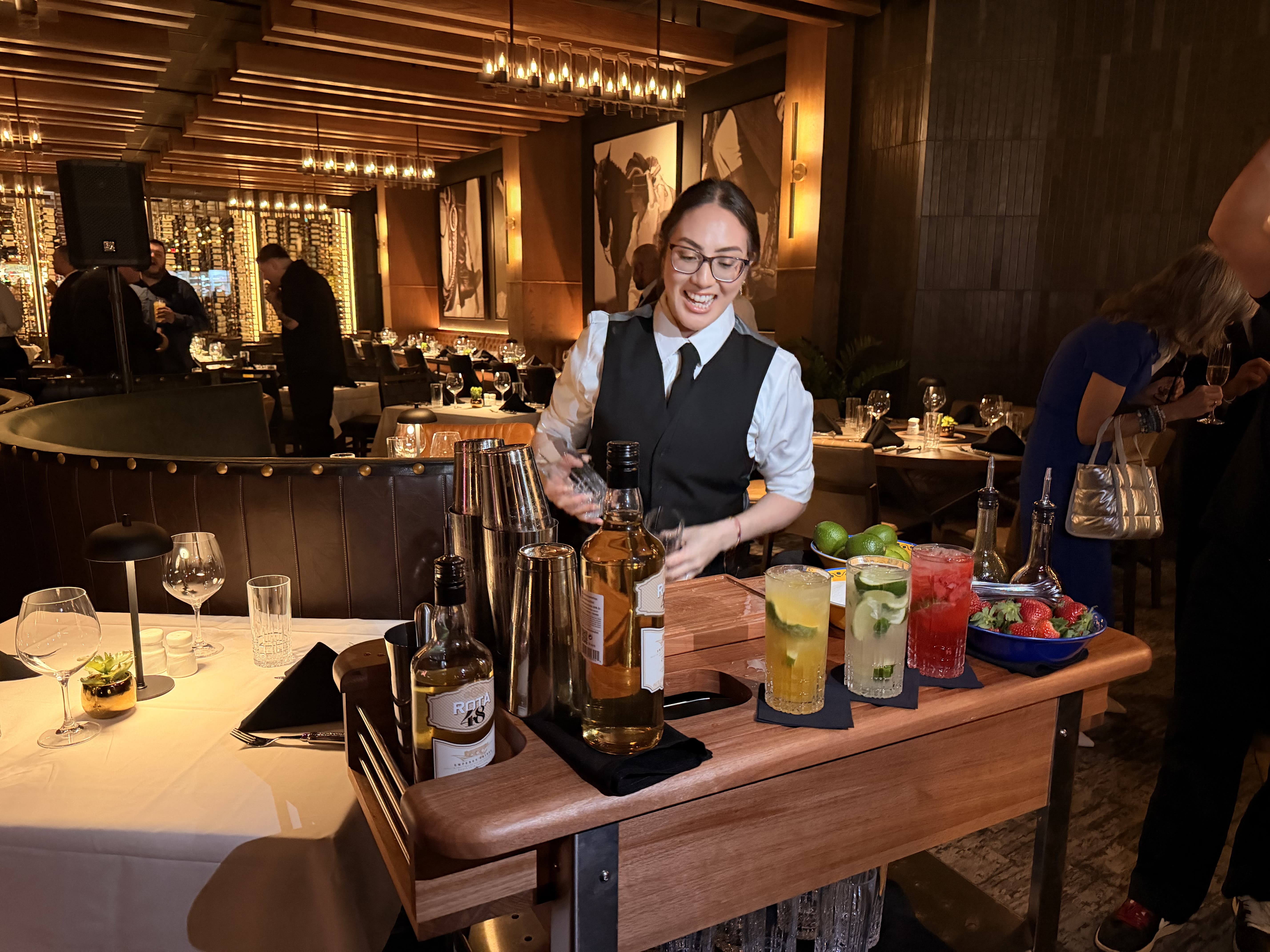 A bartender makes caipirinha cocktails on at cart at Fogo de Chao