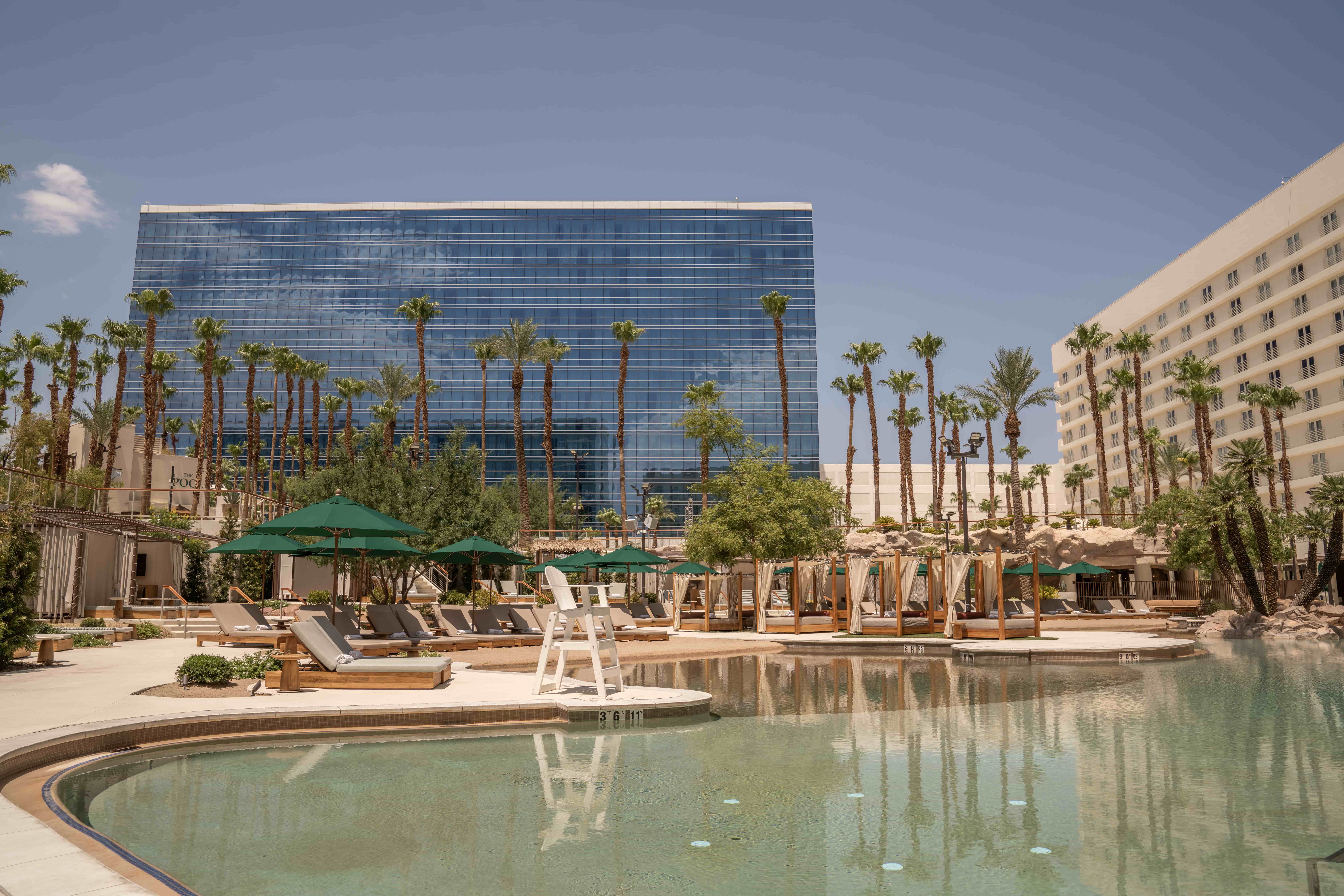 The Kassi Beach Club pool at Virgin Hotels with a sandy beach.