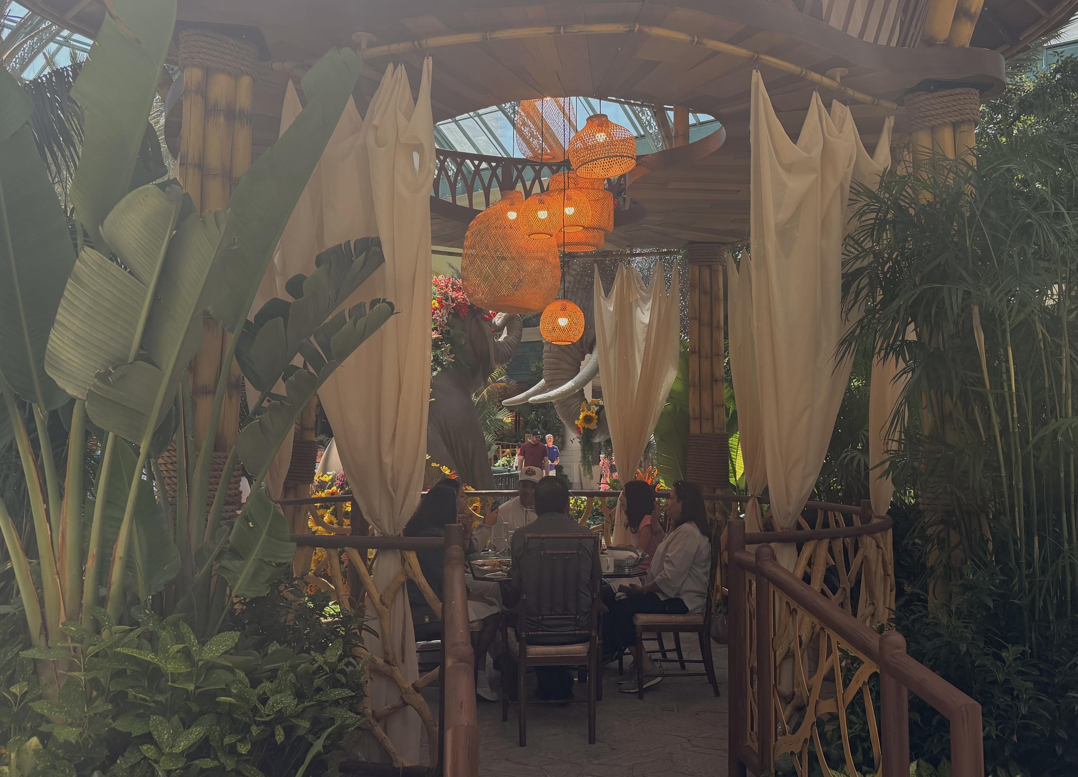 The Garden Table dining area inside of the Bellagio Conservatory's summer 2026 display during the day
