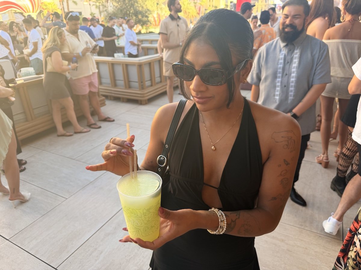 A woman with sunglasses holding a margarita at OMNIA Skybar.