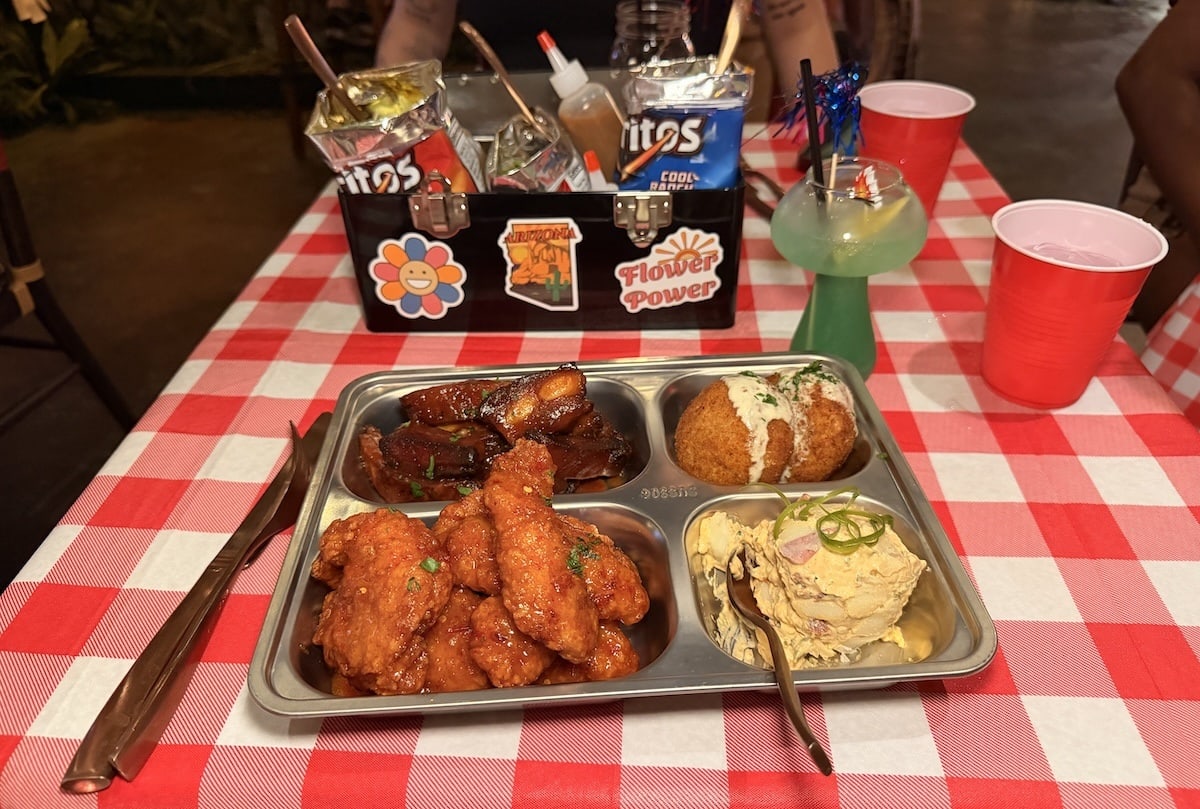 Camp Palms Band Camp Bento Box with chicken nuggets/tenders, mac and cheese balls, chipotle potato salad and barbeque rib tips.