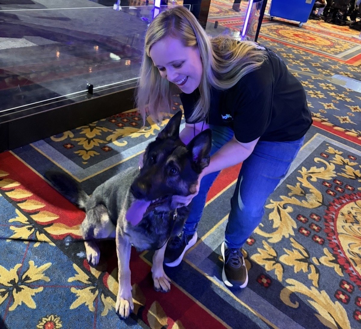 Christina Bradfield petting a bomb dog at the World Series of poker