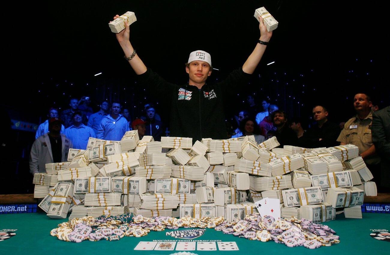 Peter Eastgate holding money in front of the grand prize for winning the WSOP Main Event in 2008.