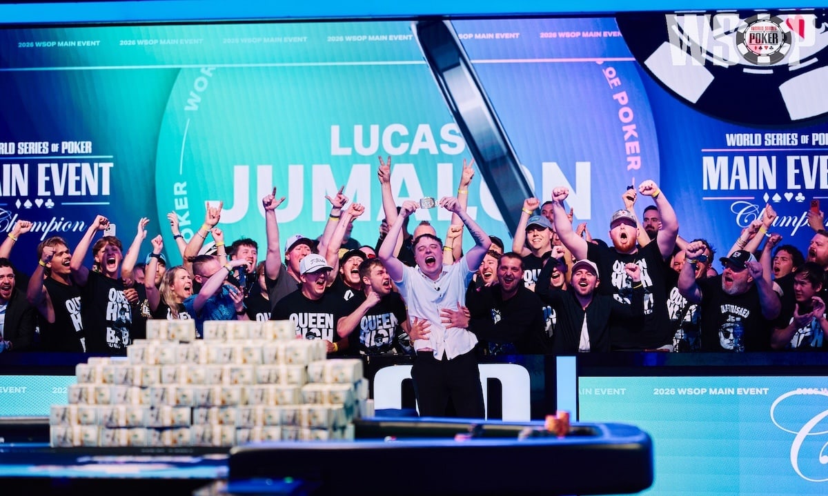Lucas Jumalon celebrates his final table win, capturing a WSOP Main Event World Champion bracelet and $10 million prize in cash on the poker table in front of him. Screens behind him are blue and purple displaying his name and World Series of Poker logos with poker chips