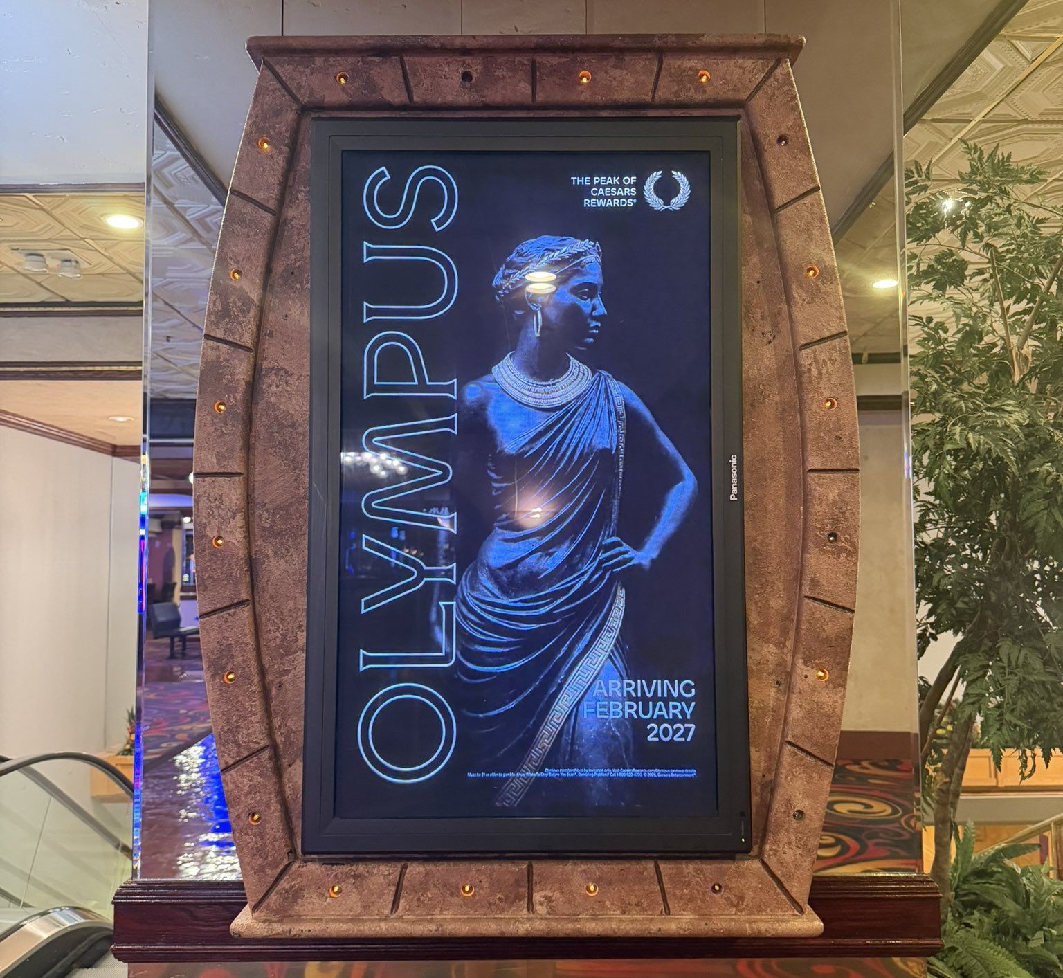 A promotional display inside a Caesars property teases the arrival of the new invite-only Olympus tier coming in February 2027.