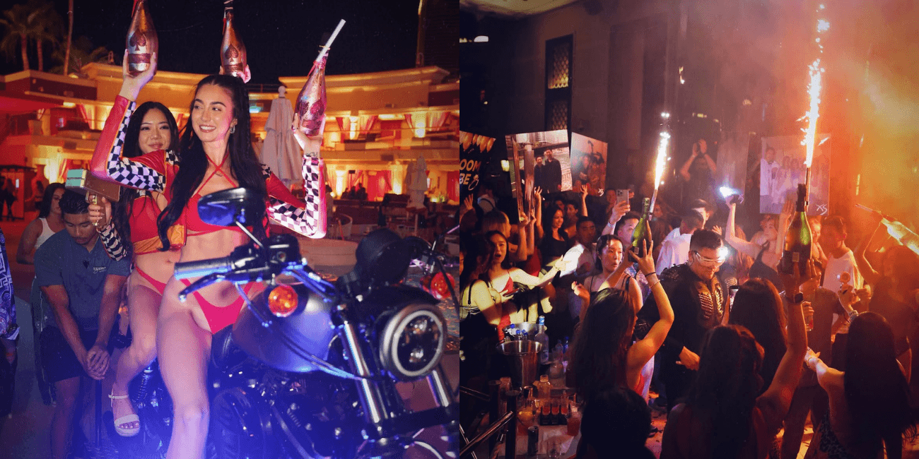 A bottle server sits with another waitress on a Harley Davidson motorcycle in a blue and red race themed outfit holding a pink metallic champagne bottles. On the right, a group of bottle service waitresses, hold champagne bottles with sparklers, and a man is pictured playing a drum set in a crowd.