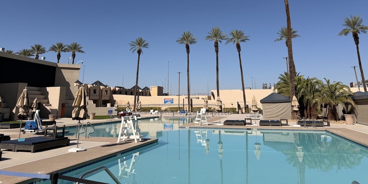 A freshly resurfaced and empty pool at Luxor's Oasis Pool in Las Vegas during the daytime lined with palm trees after a multi month renovation
