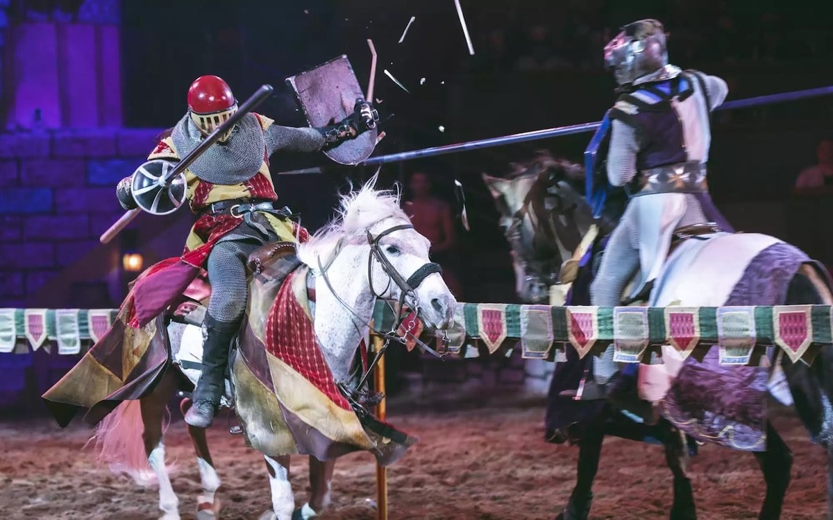 armored knights on horseback colliding lances during a jousting match