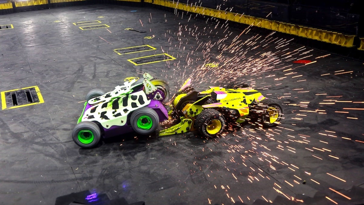 two battlebots colliding with sparks flying in an arena