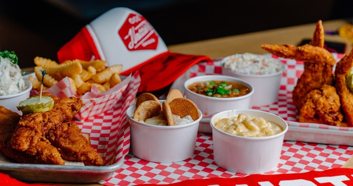 chicken tenders and sides on a red and white plaid paper mat from hattie b's at the cosmo
