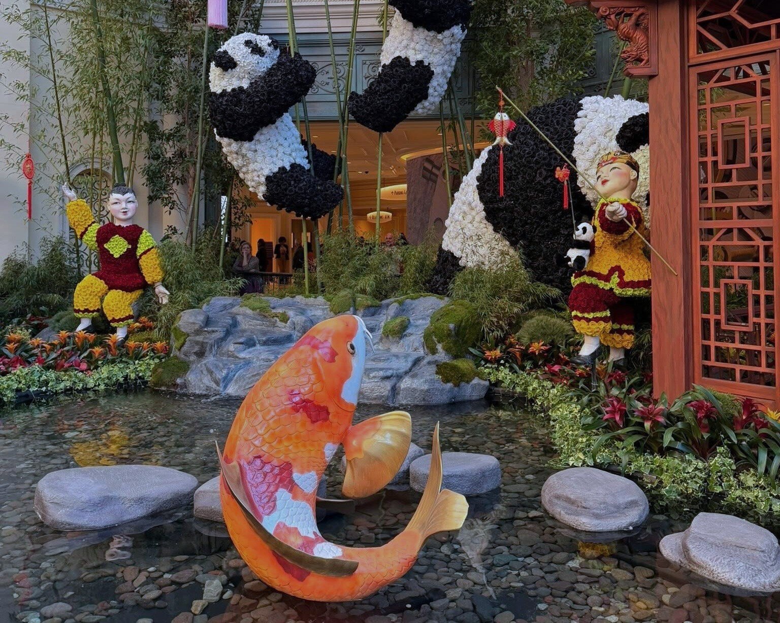 South Bed of the Bellagio Conservatory with pandas, flower children, and a koi pond.
