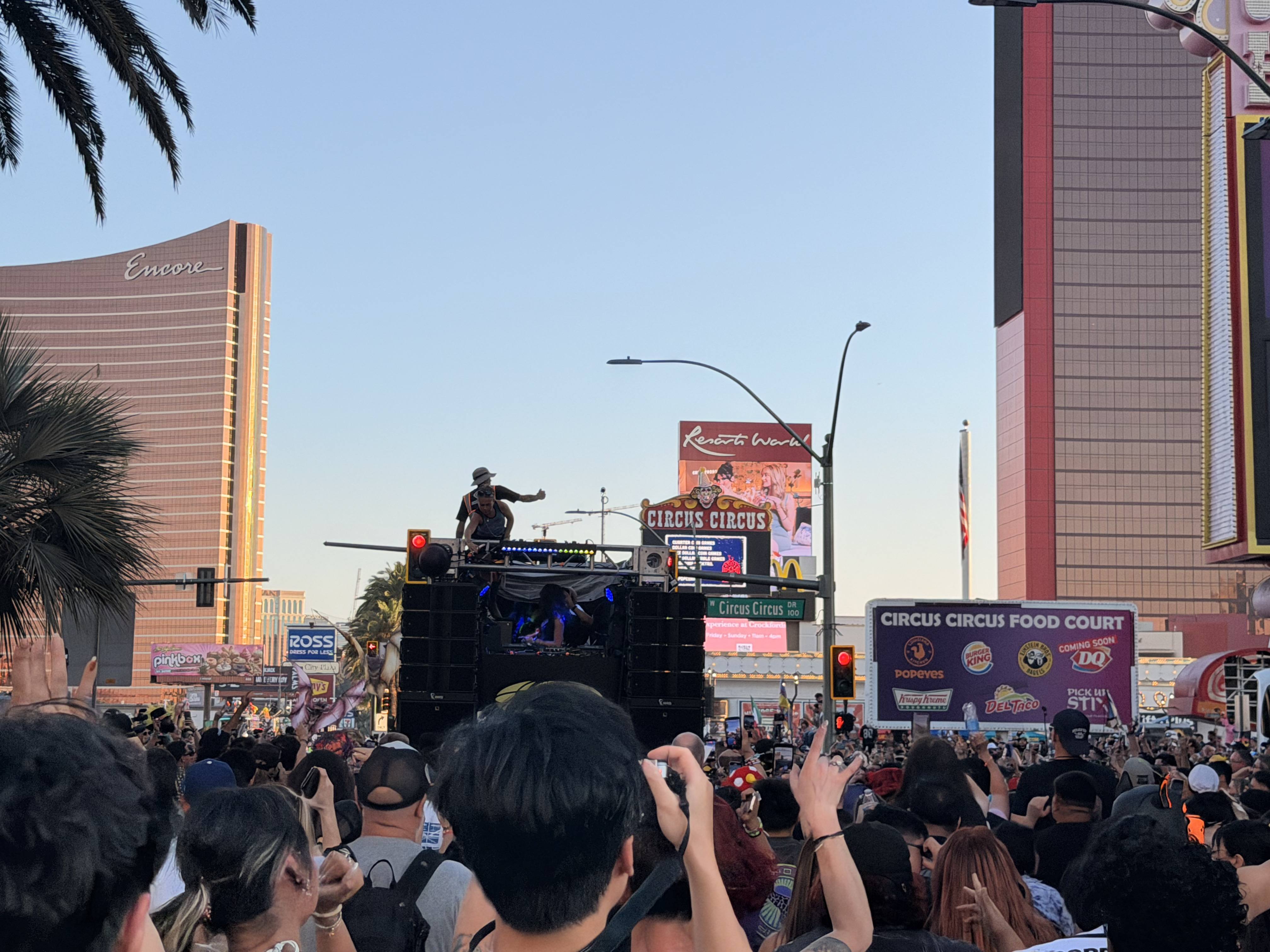 A large crowd gathers in front of Circus Circus and Resorts World for EDC's World Party Parade