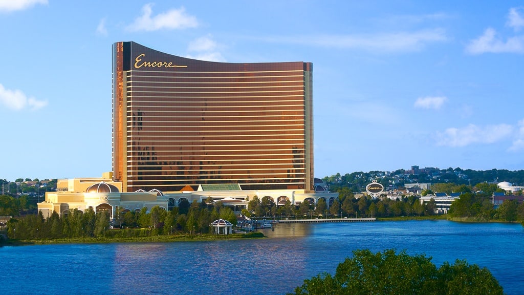 Encore Boston Harbor casino and hotel tower reflecting golden light over the Mystic River waterfront in Everett, Massachusetts