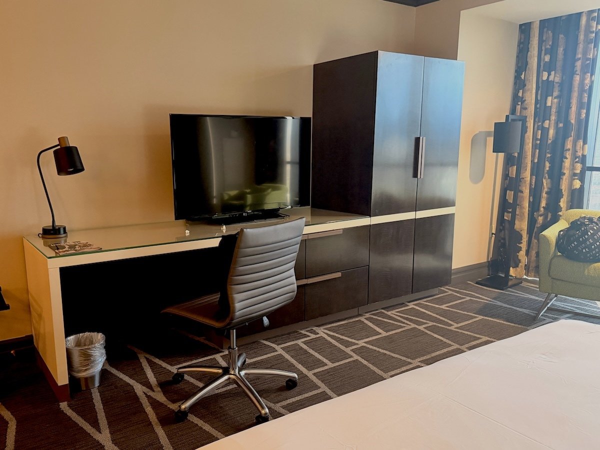 Desk, TV and wardrobe in a Tower Premier King Room at Luxor