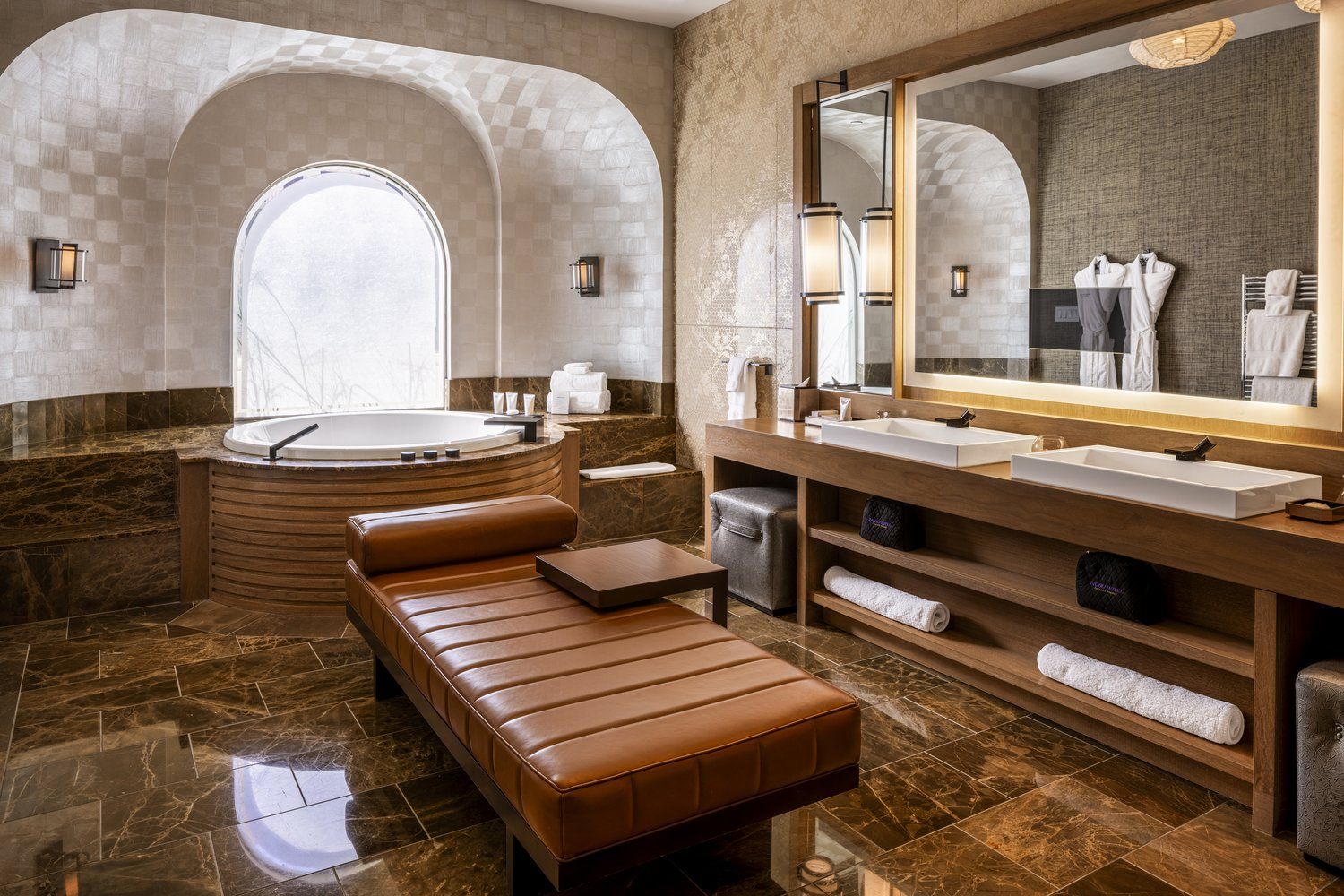 Nobu Villa primary bathroom with soaking tub, double vanity and leather chaise