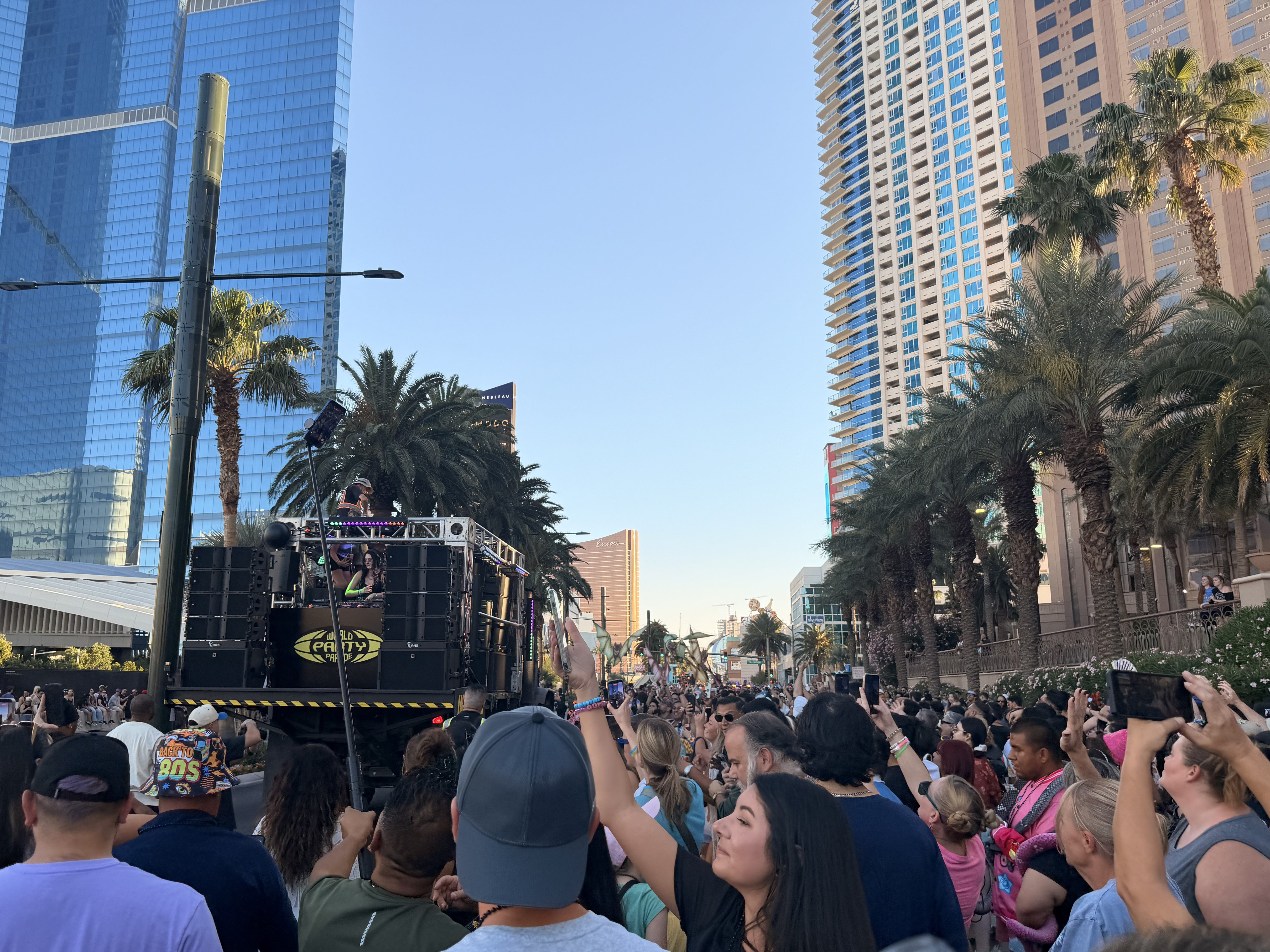 A large crowd follows the World Party Parade float on the Las Vegas Strip for EDC